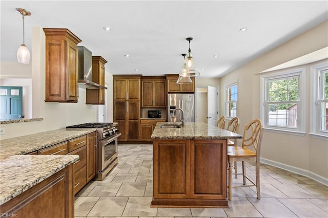 4901 Lake Shore Dr, Chesapeake, VA 23321 - kitchen with appliances with stainless steel finishes, wall chimney exhaust hood, a sink, light stone counters, and an island with sink