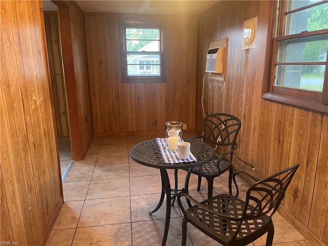 203 Windsor Ave, Smithfield, VA 23430 - dining room with wooden walls, an AC wall unit, baseboards, and light tile patterned floors