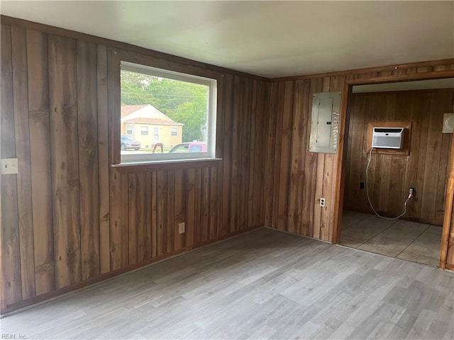 203 Windsor Ave, Smithfield, VA 23430 - spare room with electric panel, light wood finished floors, a wall mounted AC, and wooden walls