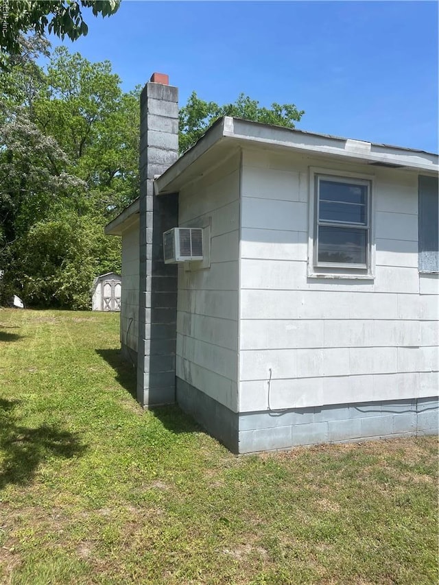 203 Windsor Ave, Smithfield, VA 23430 - view of home's exterior featuring a chimney, a yard, and a wall mounted AC