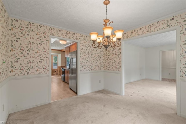 1118 Patrick Ln, Newport News, VA 23608 - unfurnished room featuring wainscoting, wallpapered walls, crown molding, a chandelier, and light carpet