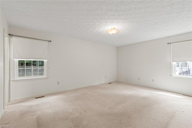 1118 Patrick Ln, Newport News, VA 23608 - carpeted spare room with a textured ceiling and baseboards