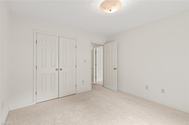 1118 Patrick Ln, Newport News, VA 23608 - unfurnished bedroom featuring light carpet, a closet, and a textured ceiling