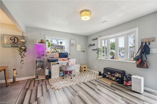 1014 Rowe St, Hampton, VA 23669 - office area with wood finished floors, healthy amount of natural light, baseboards, and a textured ceiling