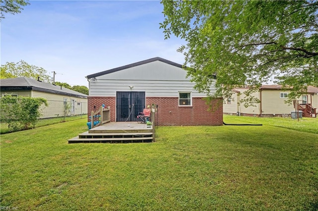 1014 Rowe St, Hampton, VA 23669 - back of property with a deck, a yard, and brick siding