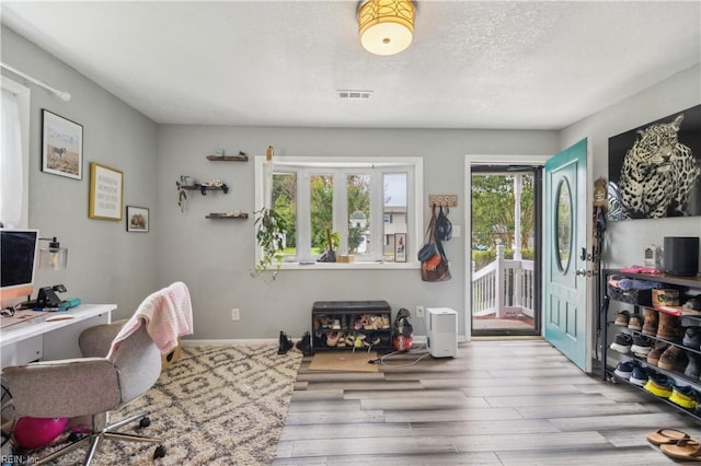 1014 Rowe St, Hampton, VA 23669 - home office featuring wood finished floors, a textured ceiling, and baseboards
