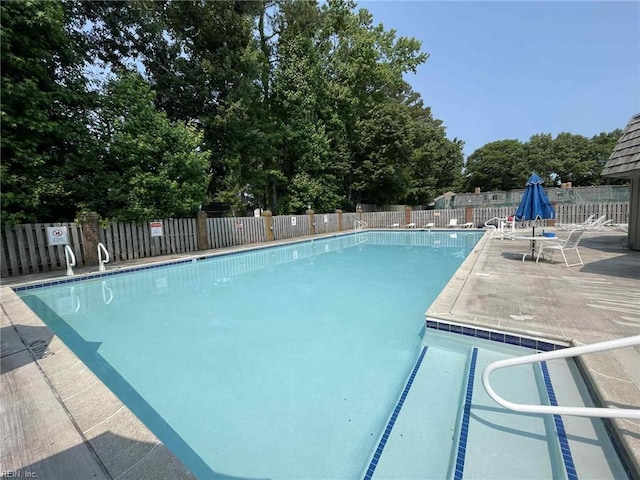 1107 Ocean Pebbles Way, Virginia Beach, VA 23451 - community pool featuring a patio area and view of scattered trees