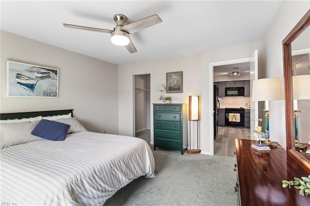 1107 Ocean Pebbles Way, Virginia Beach, VA 23451 - carpeted bedroom featuring freestanding refrigerator, a walk in closet, a ceiling fan, and a closet