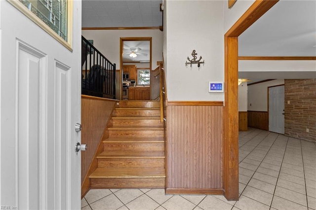 119 Waltham St, Hampton, VA 23666 - stairs featuring ornamental molding, wainscoting, ceiling fan, wooden walls, and tile patterned flooring