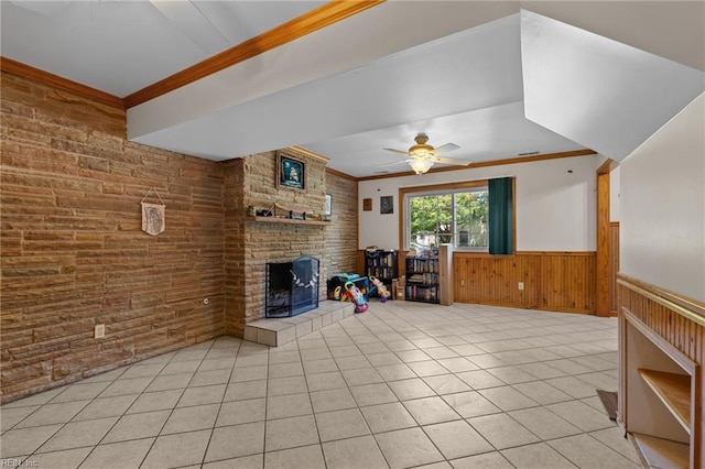 119 Waltham St, Hampton, VA 23666 - unfurnished living room featuring ornamental molding, wood walls, a tiled fireplace, light tile patterned flooring, and a wainscoted wall