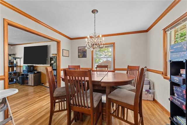 119 Waltham St, Hampton, VA 23666 - dining area with light wood-style flooring, healthy amount of natural light, a chandelier, and ornamental molding