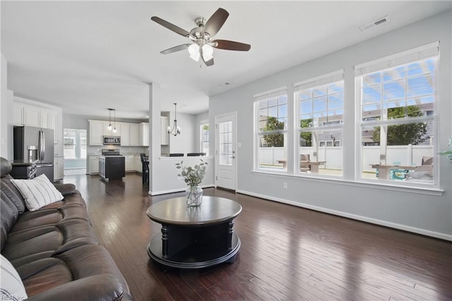 2209 Beeblossom Ln, Chesapeake, VA 23323 - living room with ceiling fan, dark wood-type flooring, baseboards, and a chandelier