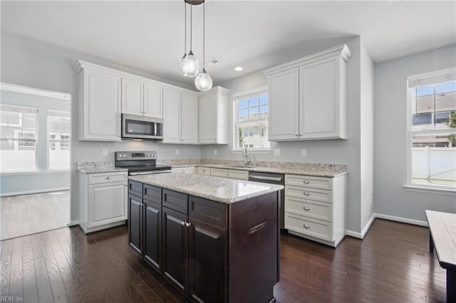 2209 Beeblossom Ln, Chesapeake, VA 23323 - kitchen featuring stainless steel appliances, white cabinetry, dark wood-type flooring, hanging light fixtures, and baseboards