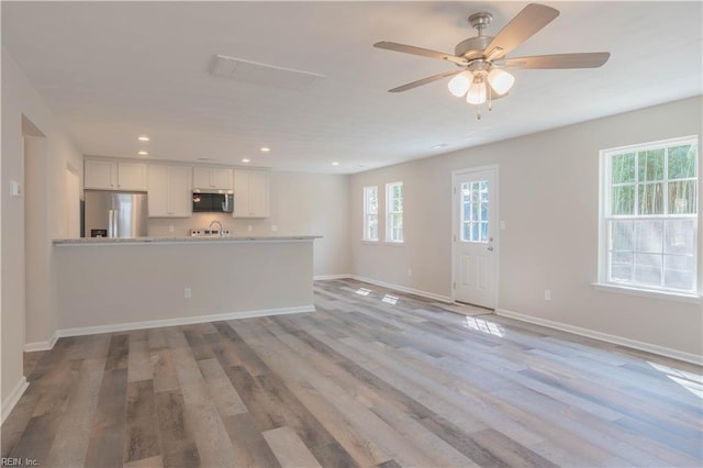 2807 Eustis Ave, Chesapeake, VA 23325 - unfurnished living room featuring healthy amount of natural light, baseboards, a ceiling fan, wood finished floors, and recessed lighting
