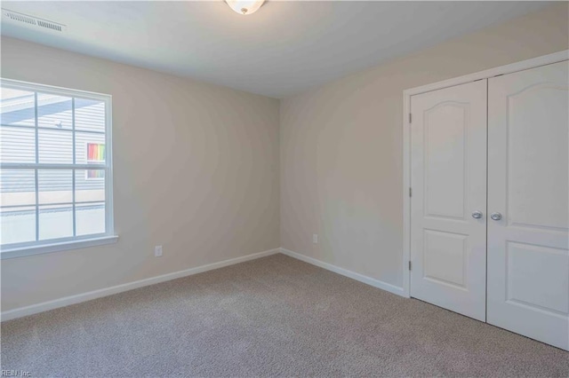 2807 Eustis Ave, Chesapeake, VA 23325 - unfurnished bedroom with carpet flooring, multiple windows, baseboards, and a closet