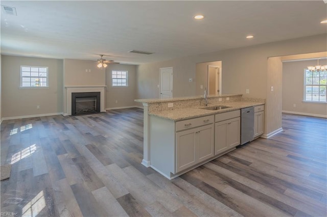 2807 Eustis Ave, Chesapeake, VA 23325 - kitchen with a sink, dishwasher, wood finished floors, a glass covered fireplace, and recessed lighting