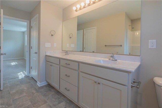 2807 Eustis Ave, Chesapeake, VA 23325 - full bathroom with double vanity, baseboards, and toilet