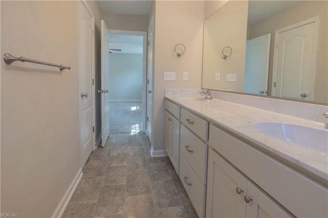 2807 Eustis Ave, Chesapeake, VA 23325 - bathroom featuring double vanity, stone finish flooring, and baseboards
