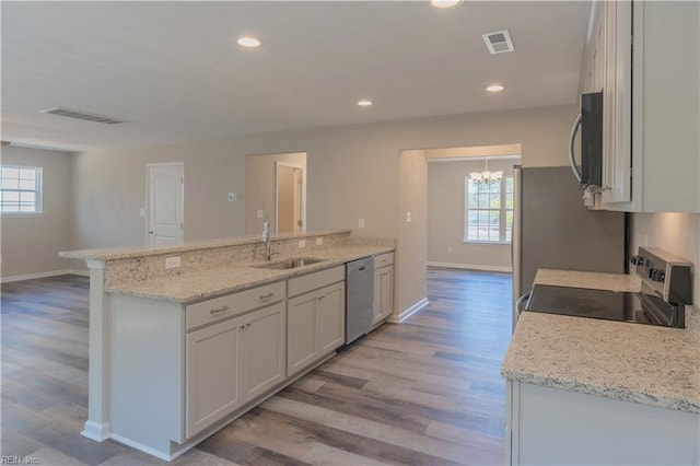 2807 Eustis Ave, Chesapeake, VA 23325 - kitchen featuring stainless steel appliances, a chandelier, a peninsula, a sink, and healthy amount of natural light