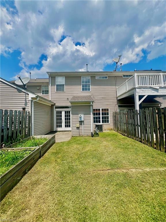 2511 Hartley St, Virginia Beach, VA 23456 - rear view of property featuring a vegetable garden, french doors, and cooling unit