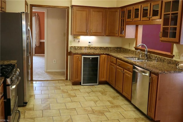 1314 Hunningdon Woods Blvd, Chesapeake, VA 23320 - kitchen with wine cooler, appliances with stainless steel finishes, a sink, brown cabinetry, and dark stone countertops