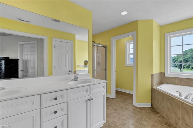 1701 Sanderson Rd, Chesapeake, VA 23322 - full bath featuring baseboards, a garden tub, double vanity, and an enclosed shower
