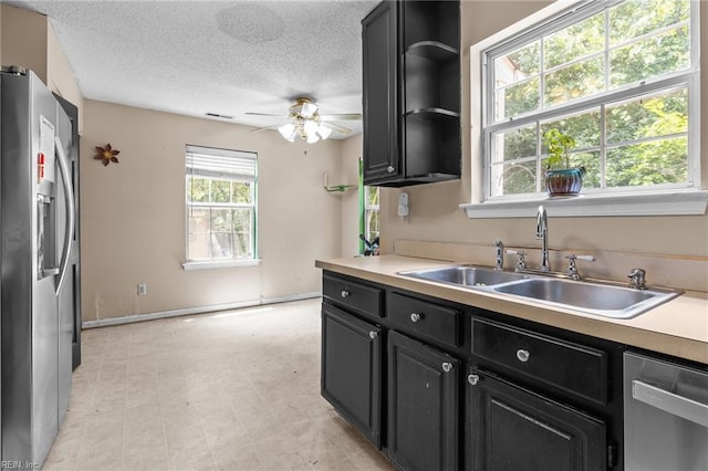 520 Kemp Lndg, Suffolk, VA 23434 - kitchen with appliances with stainless steel finishes, dark cabinetry, a textured ceiling, ceiling fan, and light countertops