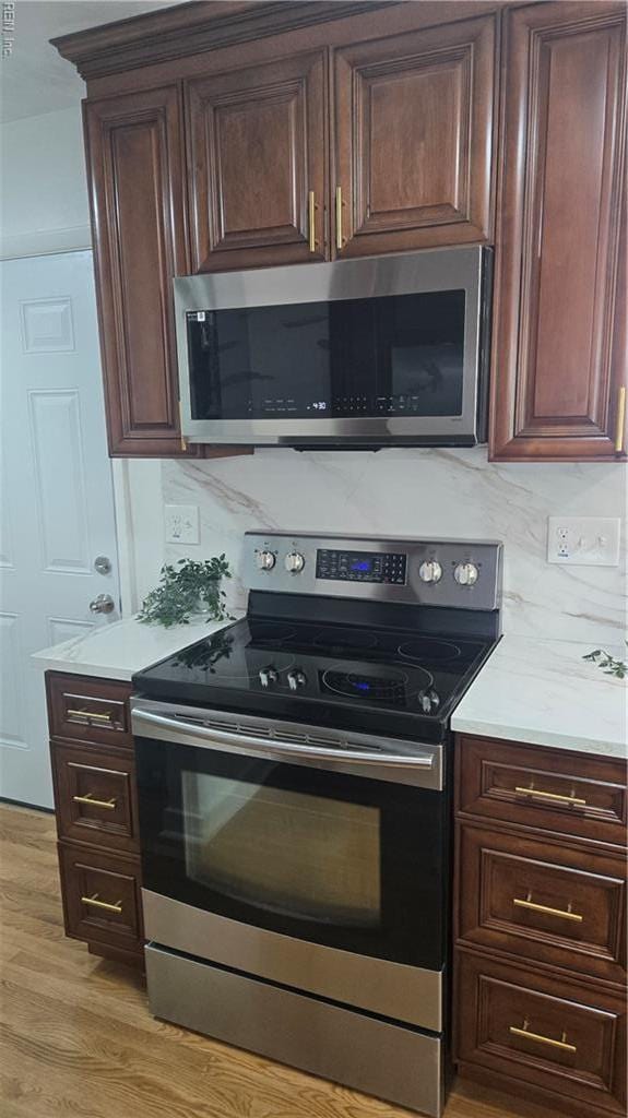 5604 Pontiac Rd, Virginia Beach, VA 23462 - kitchen with appliances with stainless steel finishes, light wood-style floors, light countertops, and dark brown cabinetry