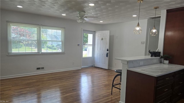 5604 Pontiac Rd, Virginia Beach, VA 23462 - kitchen featuring ceiling fan, light countertops, dark wood-style floors, baseboards, and a kitchen bar