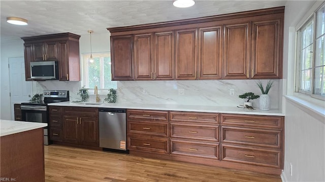 5604 Pontiac Rd, Virginia Beach, VA 23462 - kitchen featuring appliances with stainless steel finishes, a sink, decorative light fixtures, light countertops, and tasteful backsplash