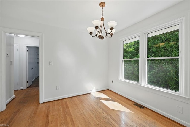 404 Forest Hill Cres, Suffolk, VA 23434 - empty room with light wood-style flooring, a chandelier, and baseboards