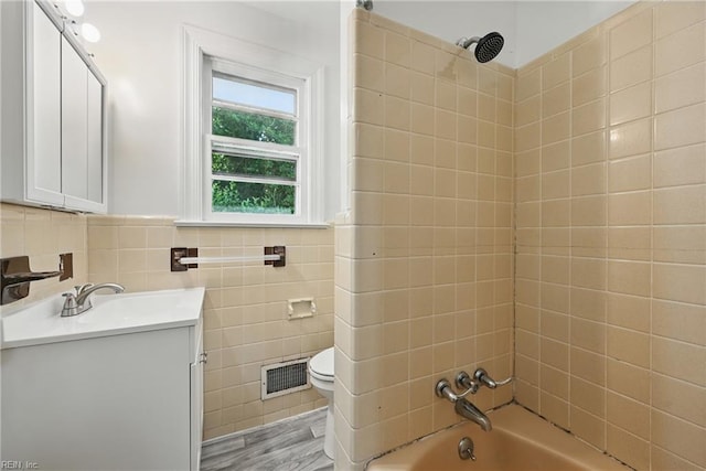 404 Forest Hill Cres, Suffolk, VA 23434 - bathroom with vanity, tub / shower combination, toilet, tile walls, and wood finished floors