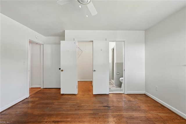 404 Forest Hill Cres, Suffolk, VA 23434 - unfurnished bedroom featuring a closet, a walk in closet, ensuite bath, wood finished floors, and baseboards