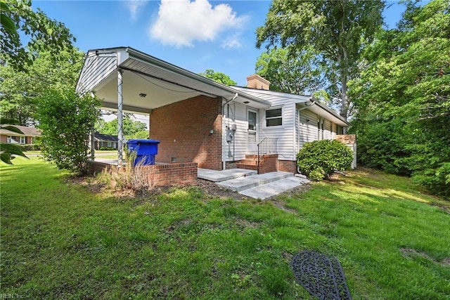 404 Forest Hill Cres, Suffolk, VA 23434 - back of property with a chimney, a yard, and brick siding
