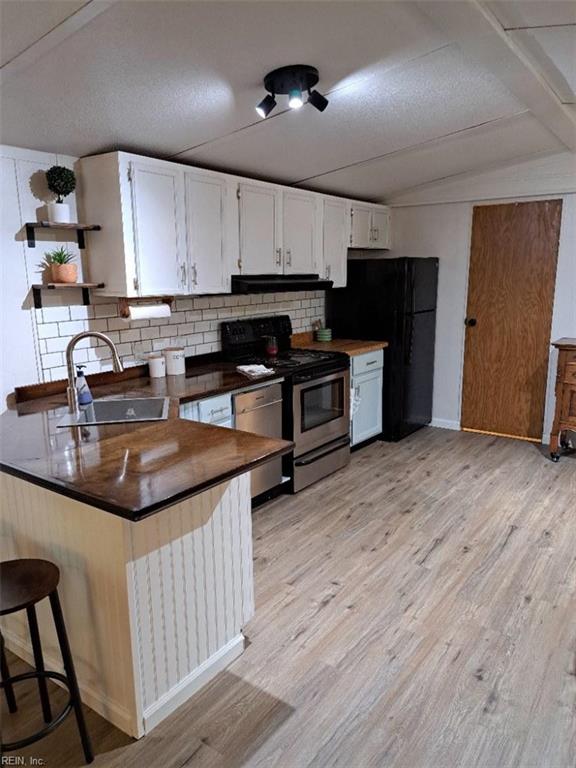 9917 Friendship Rd, North, VA 23128 - kitchen featuring a sink, dark countertops, open shelves, stainless steel range oven, and decorative backsplash