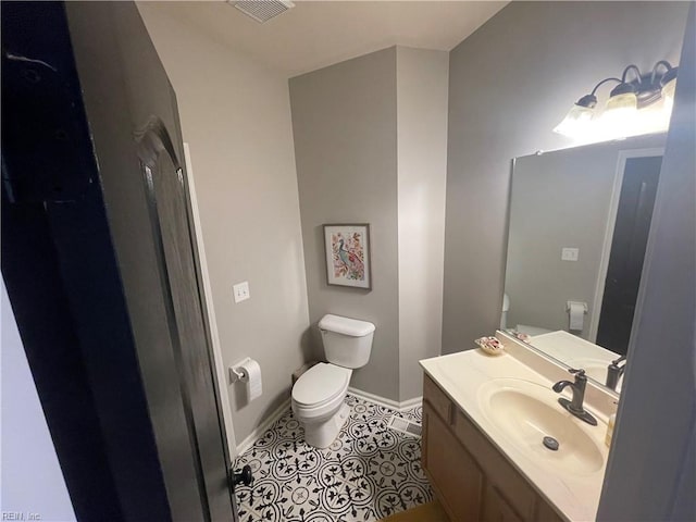 131 Hawks Nest Ln, Suffolk, VA 23435 - bathroom with toilet, baseboards, vanity, and tile patterned floors