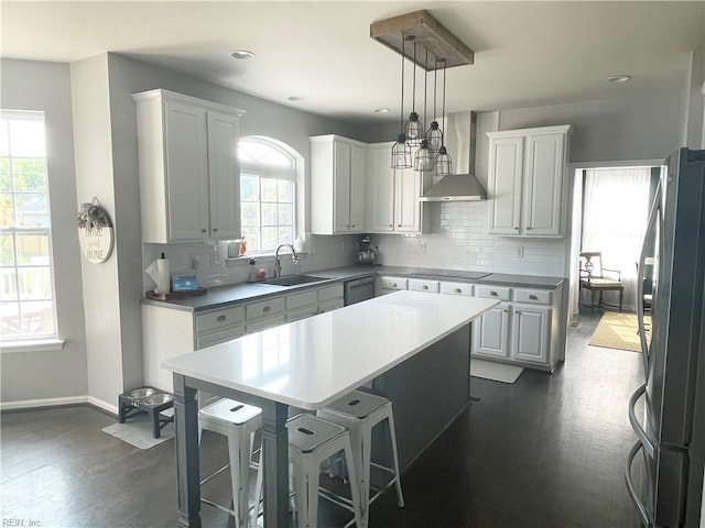 131 Hawks Nest Ln, Suffolk, VA 23435 - kitchen featuring wall chimney exhaust hood, appliances with stainless steel finishes, a sink, a center island, and dark wood-style flooring