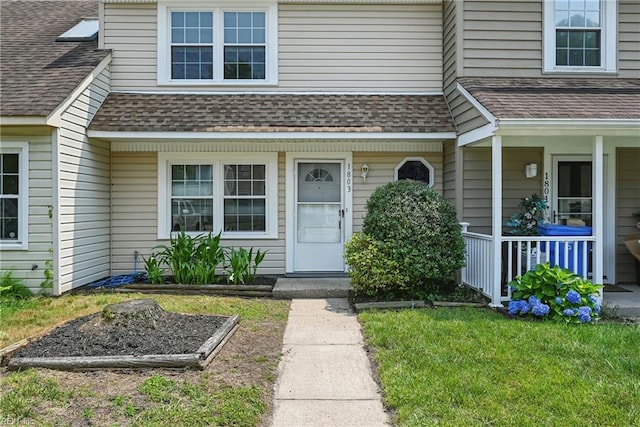 1803 Carrollwood Cmn, Chesapeake, VA 23320 - doorway to property with a shingled roof, covered porch, and a lawn