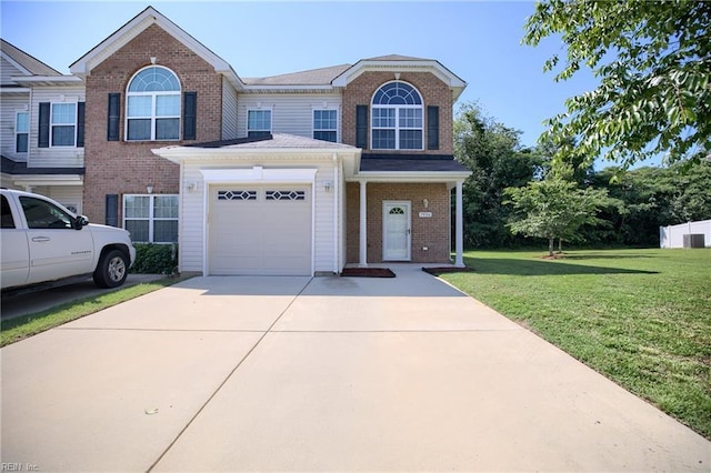 7556 Villa Ct, Gloucester, VA 23061 - multi unit property featuring concrete driveway, a front yard, an attached garage, and brick siding