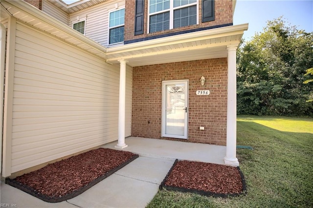 7556 Villa Ct, Gloucester, VA 23061 - entrance to property with a lawn, covered porch, and brick siding