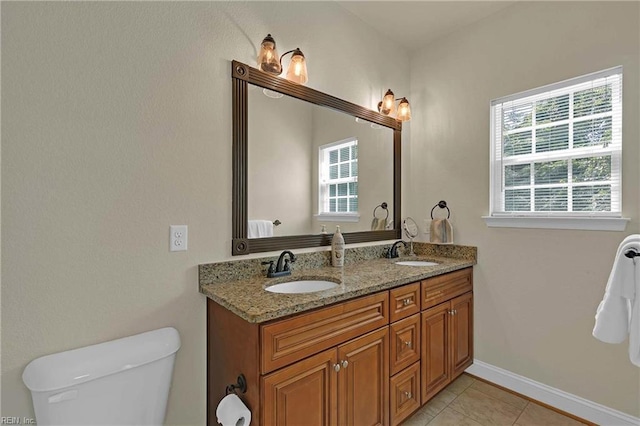 7556 Villa Ct, Gloucester, VA 23061 - bathroom with plenty of natural light, double vanity, toilet, and tile patterned floors