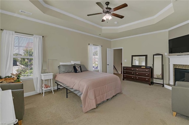 7556 Villa Ct, Gloucester, VA 23061 - carpeted bedroom featuring a tray ceiling, crown molding, a premium fireplace, baseboards, and a ceiling fan