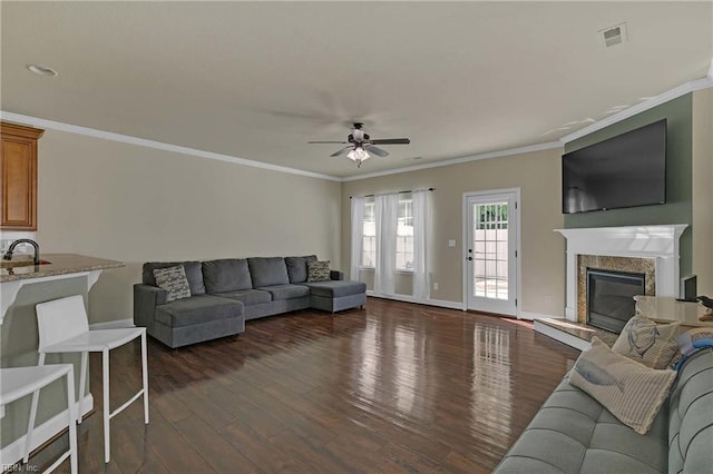 7556 Villa Ct, Gloucester, VA 23061 - living room with ceiling fan, dark wood finished floors, crown molding, baseboards, and a fireplace