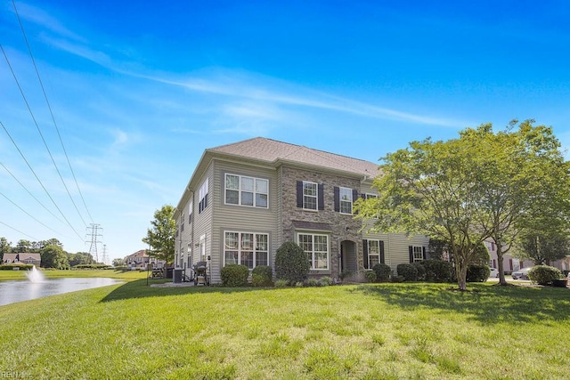 3101 Bridgewater Dr, Carrollton, VA 23314 - view of front of house featuring a front lawn, stone siding, and a water view