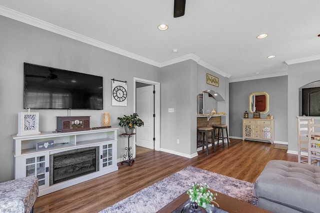 3101 Bridgewater Dr, Carrollton, VA 23314 - living room with wood finished floors, crown molding, recessed lighting, baseboards, and a fireplace