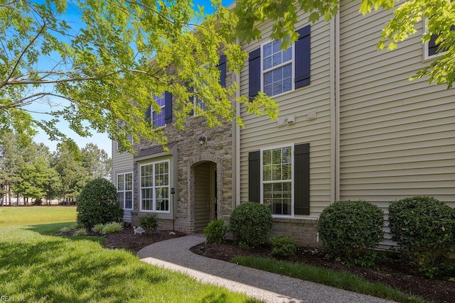 3101 Bridgewater Dr, Carrollton, VA 23314 - view of front facade featuring stone siding and a front lawn