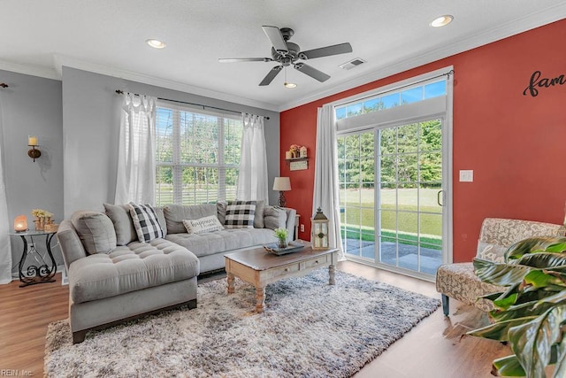 3101 Bridgewater Dr, Carrollton, VA 23314 - living area featuring healthy amount of natural light, wood finished floors, a ceiling fan, recessed lighting, and crown molding
