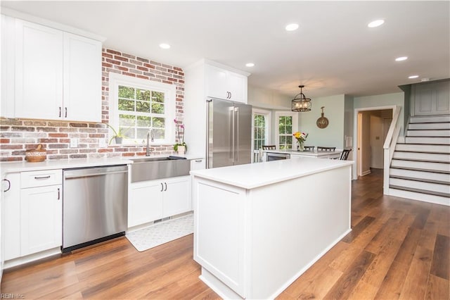 613 S Claypool Ct, Virginia Beach, VA 23464 - kitchen with appliances with stainless steel finishes, a sink, a kitchen island, light countertops, and recessed lighting