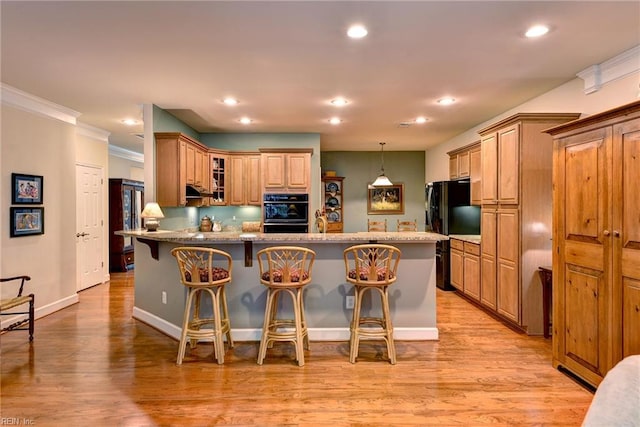 4108 Windmill Rd, Williamsburg, VA 23188 - kitchen featuring a breakfast bar area, recessed lighting, light wood finished floors, crown molding, and glass insert cabinets