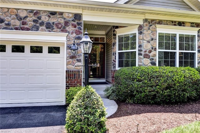4108 Windmill Rd, Williamsburg, VA 23188 - entrance to property with a garage, stone siding, and covered porch